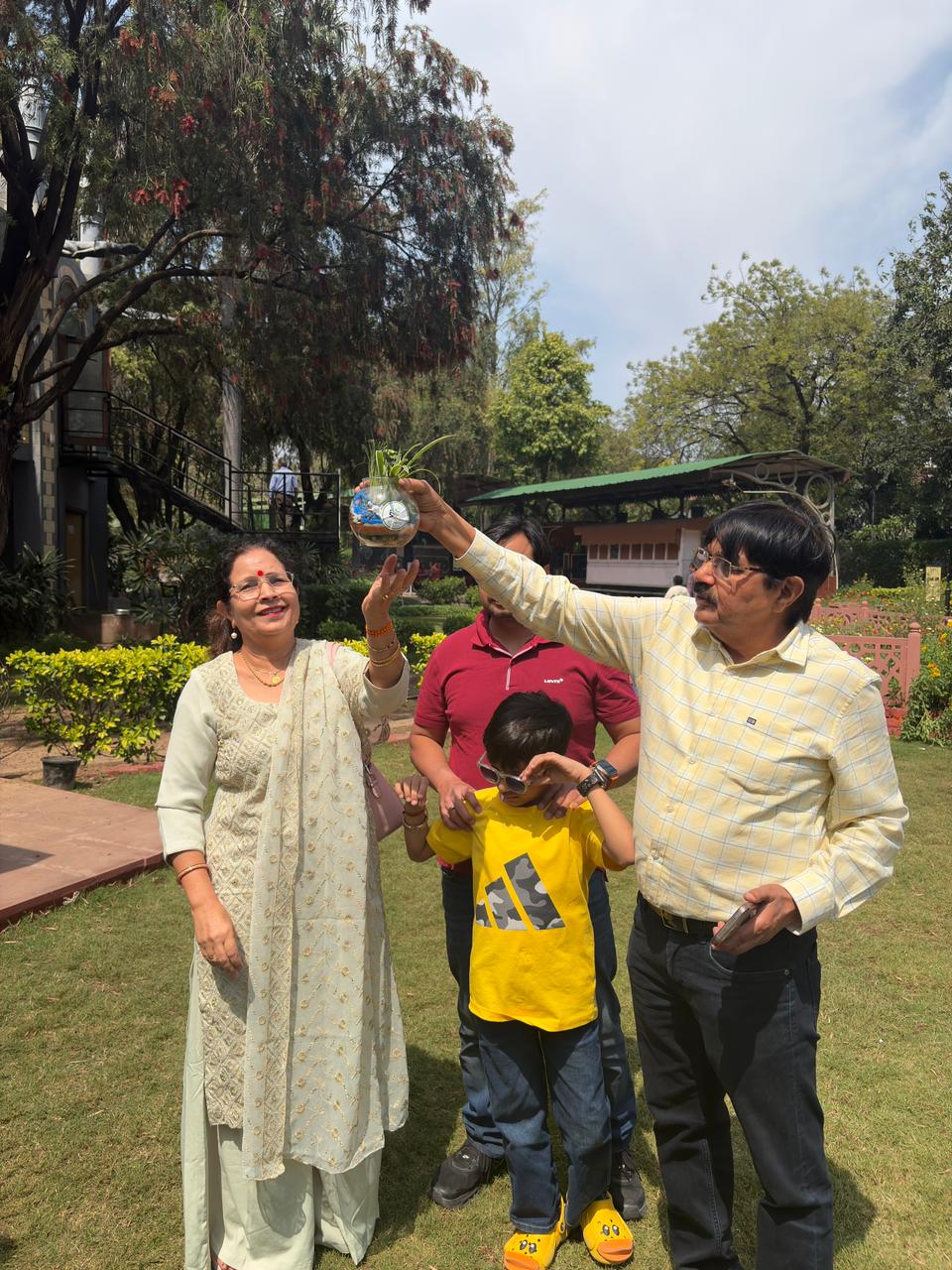 Family proudly displaying a completed terrarium outdoors