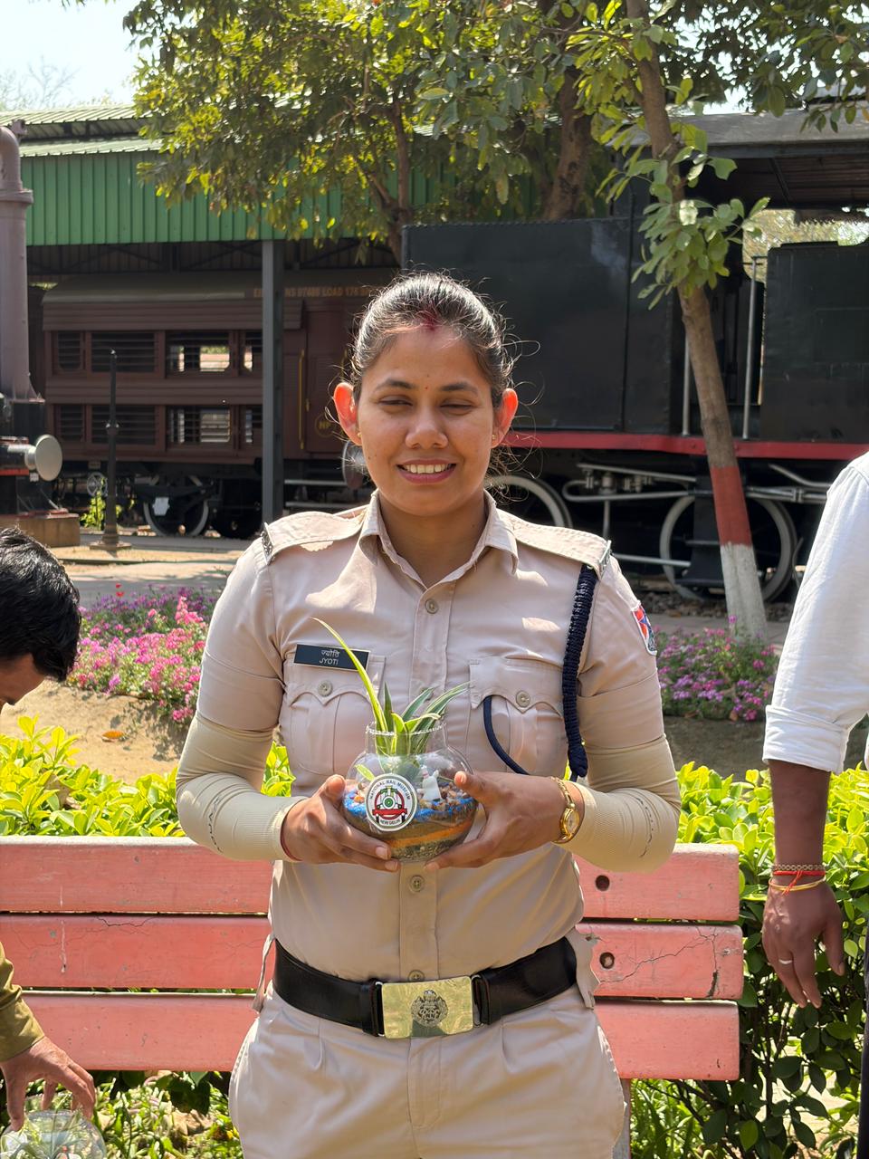 Participant proudly presenting a completed terrarium at the start of the showcase