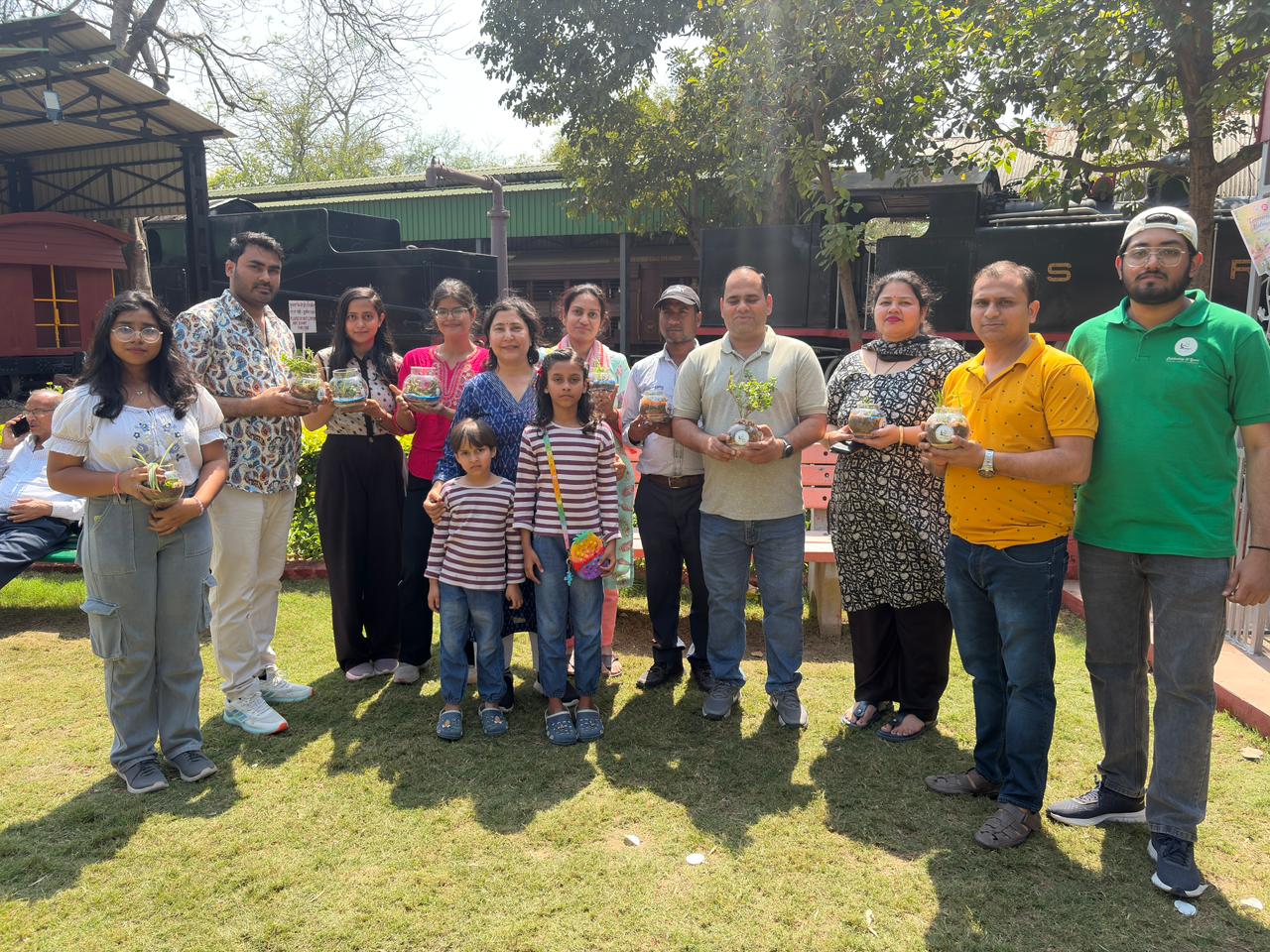 Group portrait of workshop participants holding their finished terrariums