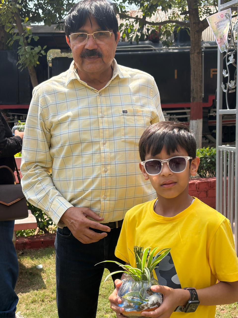 Participant child with terrarium and parent after the session