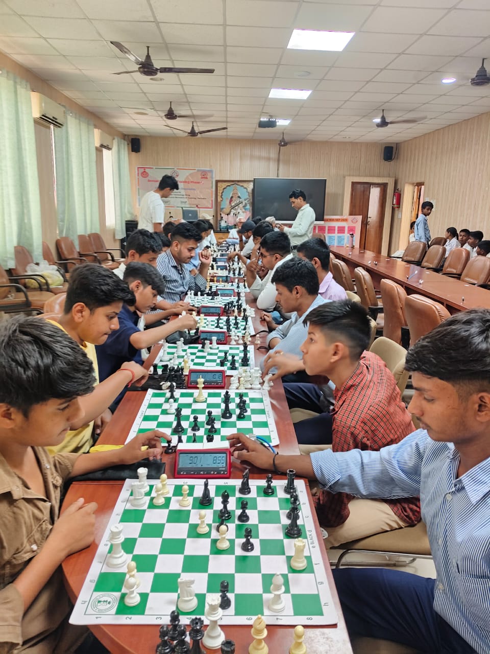 Excited players sitting around chess match tables