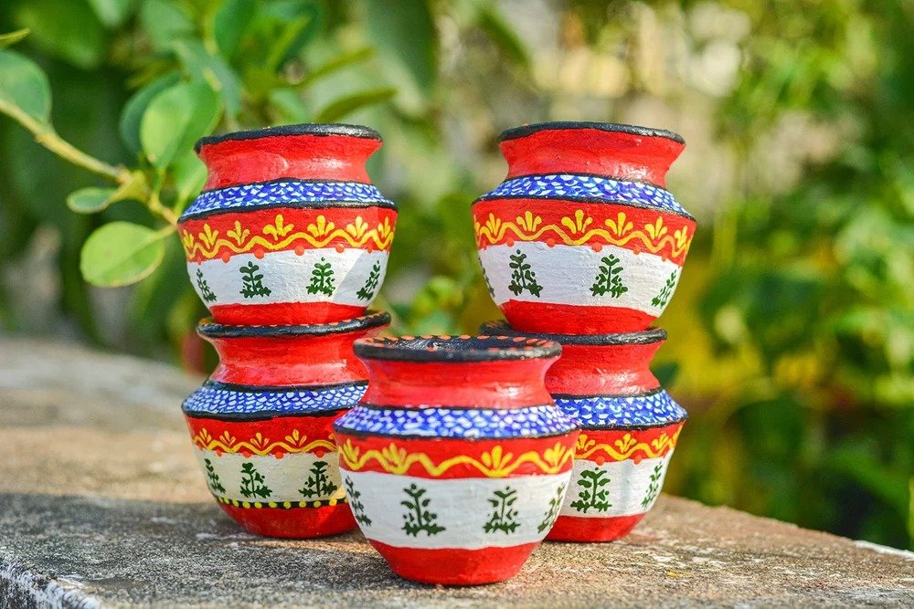 Painted earthen pots and green landscaping